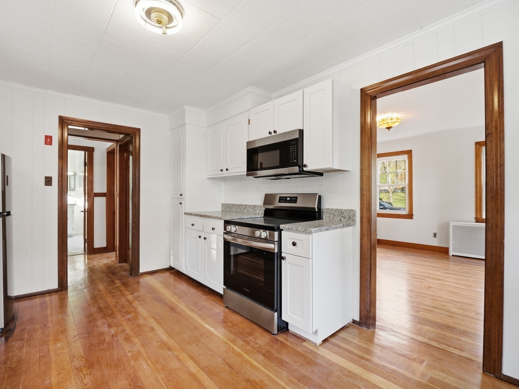 285 West Meadow Road Lowell, MA 01854 - Photo 5 of 32 a kitchen with stainless steel appliances a stove top oven and a refrigerator