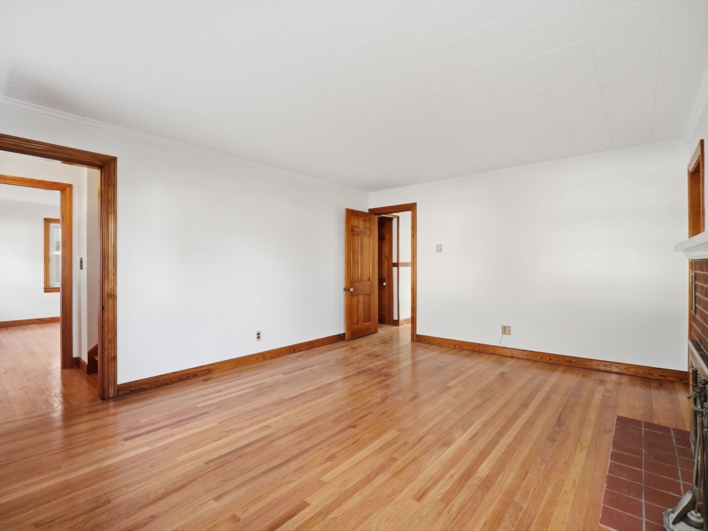 285 West Meadow Road Lowell, MA 01854 - Photo 10 of 32 a view of an empty room with wooden floor and a window