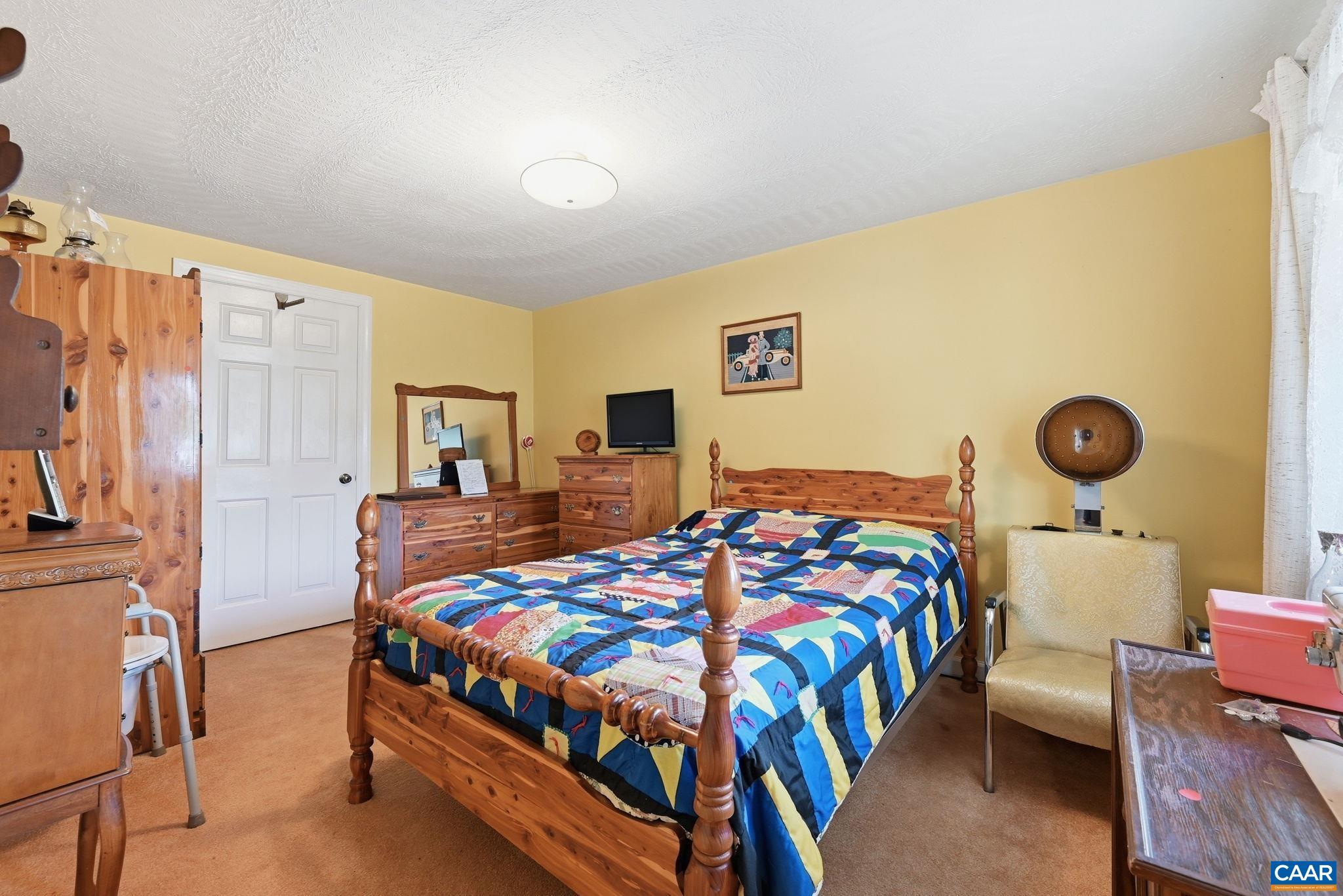 10002 Dyke Road Stanardsville, VA 22973 - Photo 11 of 73 a bedroom with a bed and dresser