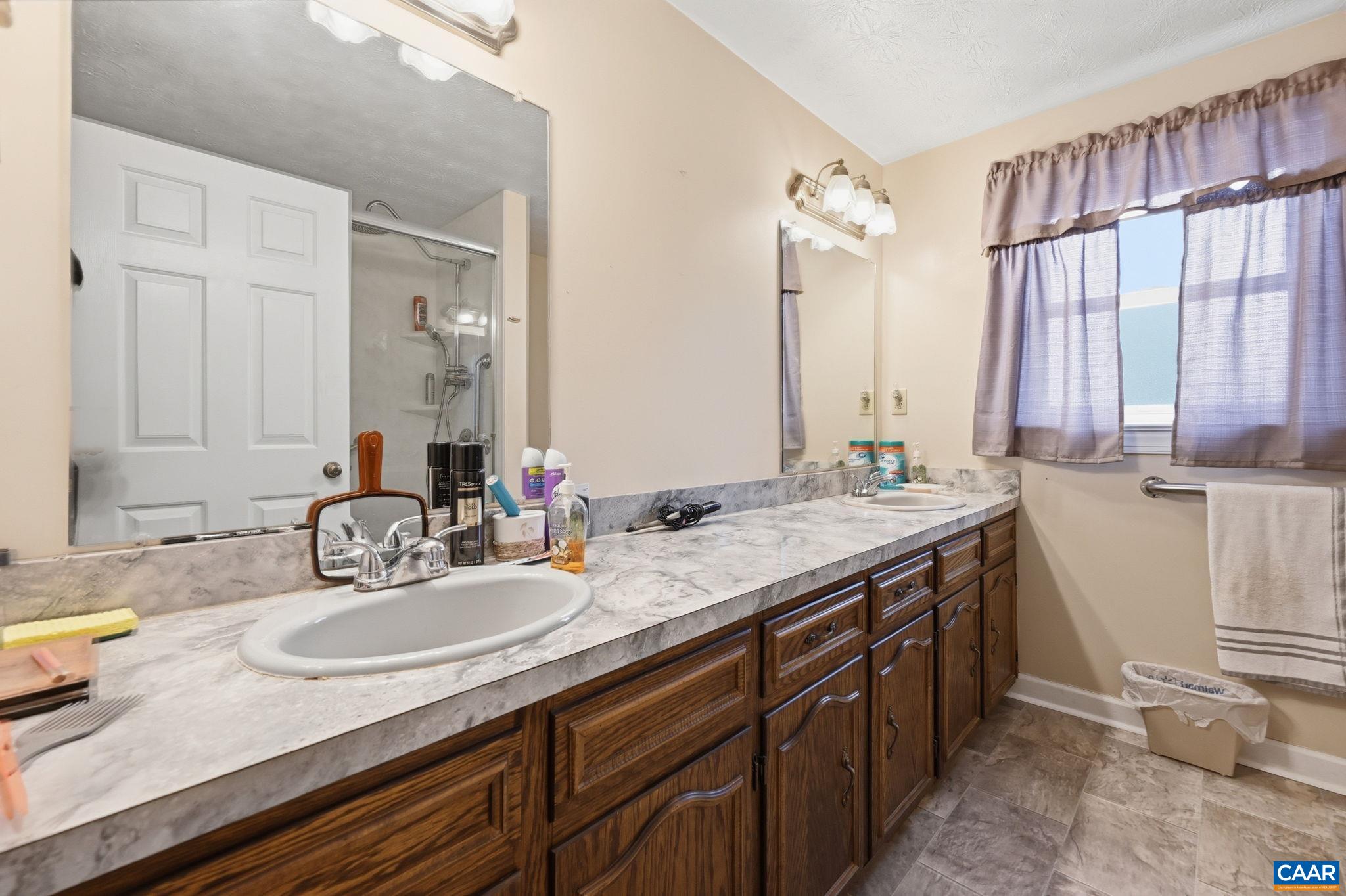 10002 Dyke Road Stanardsville, VA 22973 - Photo 17 of 73 a bathroom with a granite countertop sink and a mirror