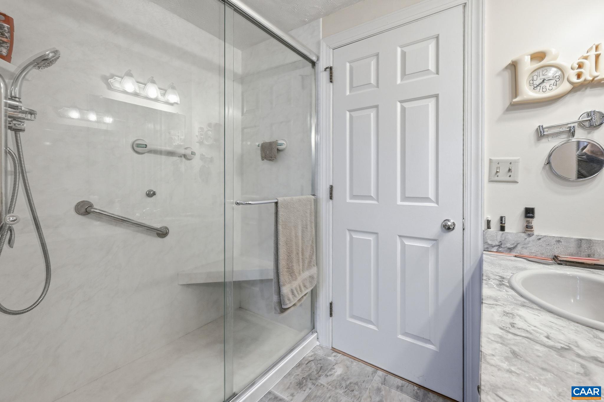 10002 Dyke Road Stanardsville, VA 22973 - Photo 18 of 73 a bathroom with a granite countertop shower and a sink