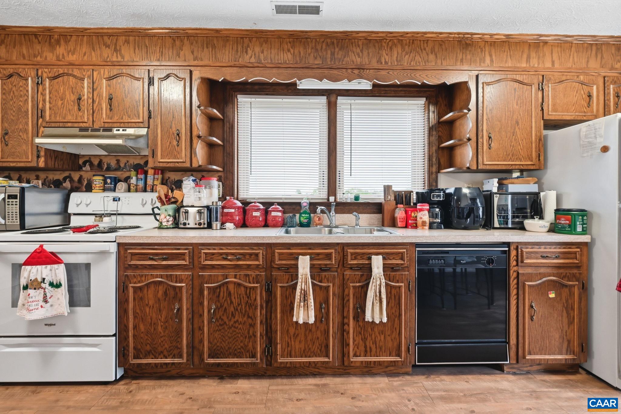 10002 Dyke Road Stanardsville, VA 22973 - Photo 27 of 73 a kitchen with stainless steel appliances granite countertop a sink and cabinets