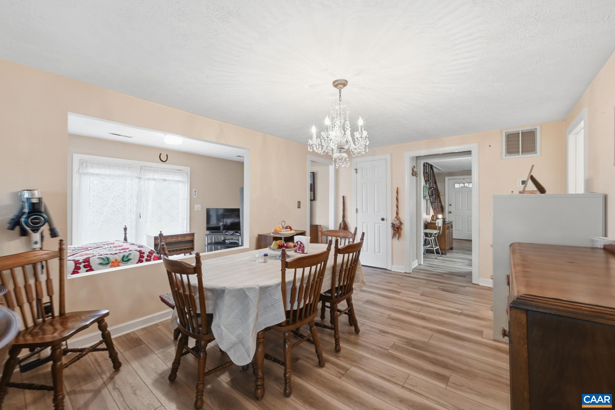10002 Dyke Road Stanardsville, VA 22973 - Photo 30 of 73 a view of a dining room with furniture and wooden floor