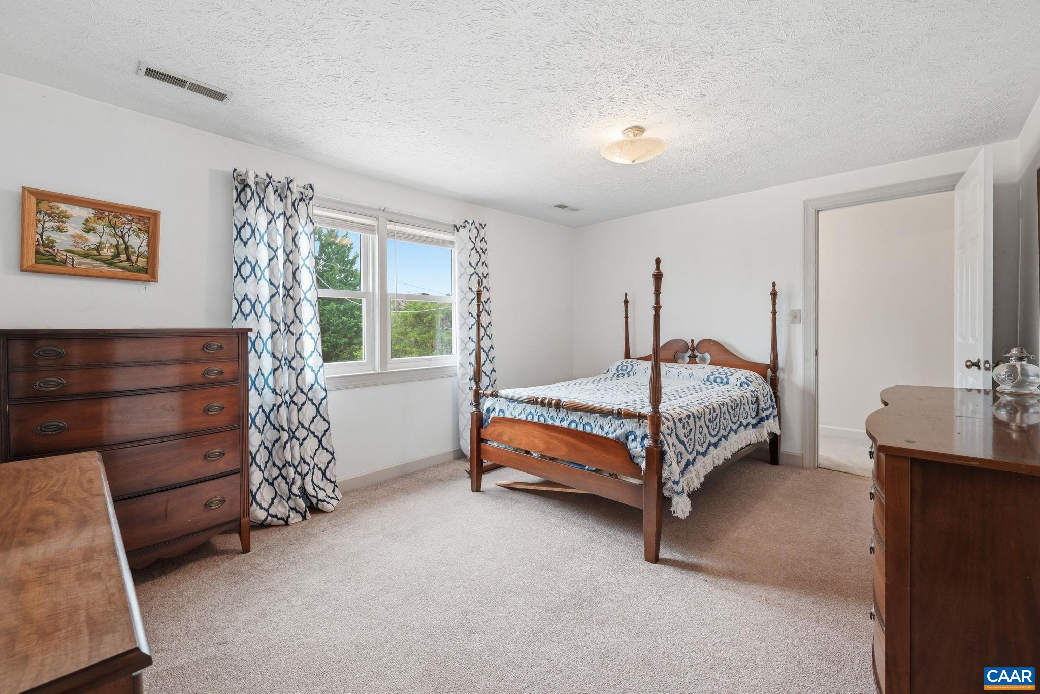 10002 Dyke Road Stanardsville, VA 22973 - Photo 32 of 73 a bedroom with a bed and a table