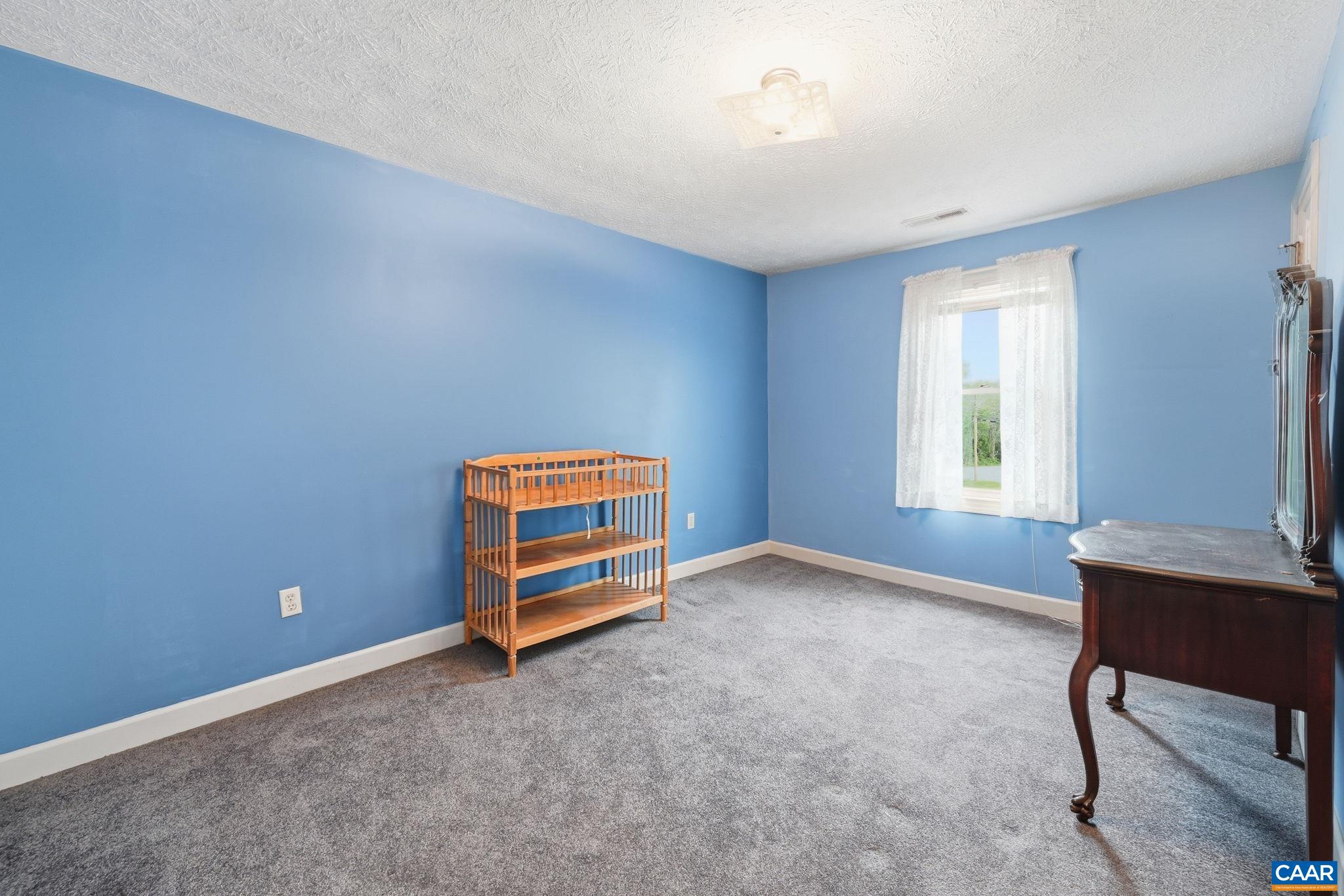 10002 Dyke Road Stanardsville, VA 22973 - Photo 34 of 73 a room with a window and a chair