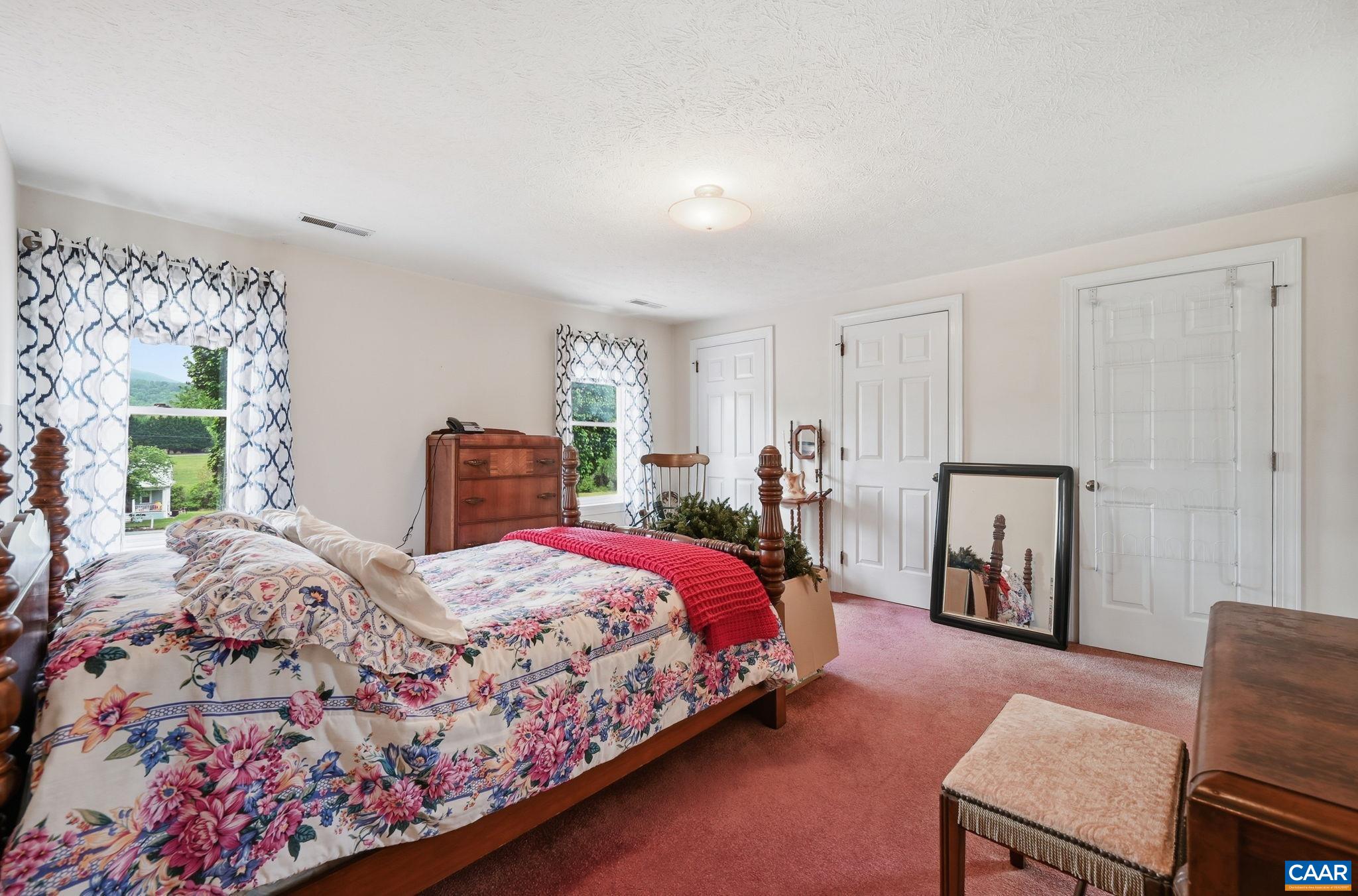 10002 Dyke Road Stanardsville, VA 22973 - Photo 36 of 73 a bedroom with a large bed and a couch