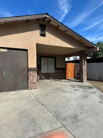 a view of a house with a small yard and plants