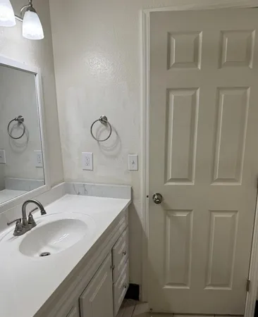 a bathroom with a sink and mirror