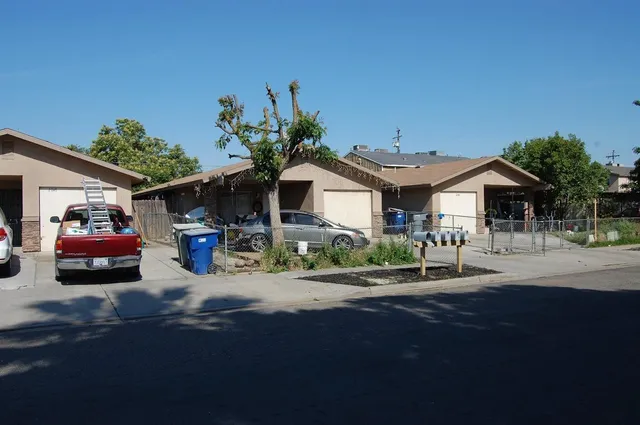 a car parked in front of white house