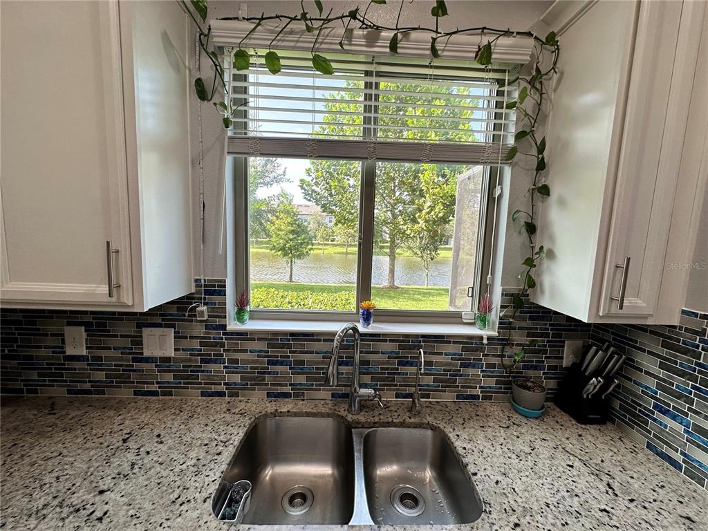 250 Rustic Loop Sanford, FL 32771 - Photo 8 of 33 a kitchen with a sink a window and cabinets