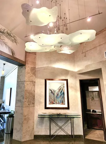 a living room with patio furniture and a floor to ceiling window