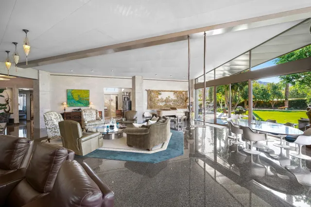 a view of a patio with a yard and palm trees