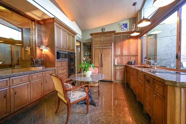 a view of a patio with table and chairs potted plants and a large tree