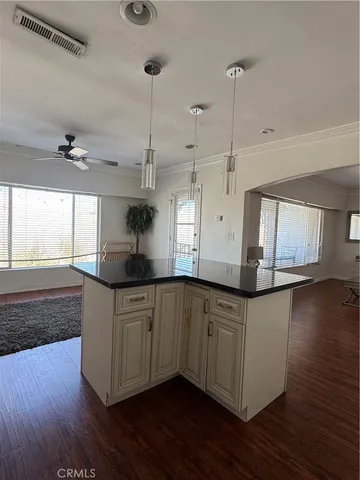 a kitchen with stainless steel appliances granite countertop a sink a stove a refrigerator and wooden floor