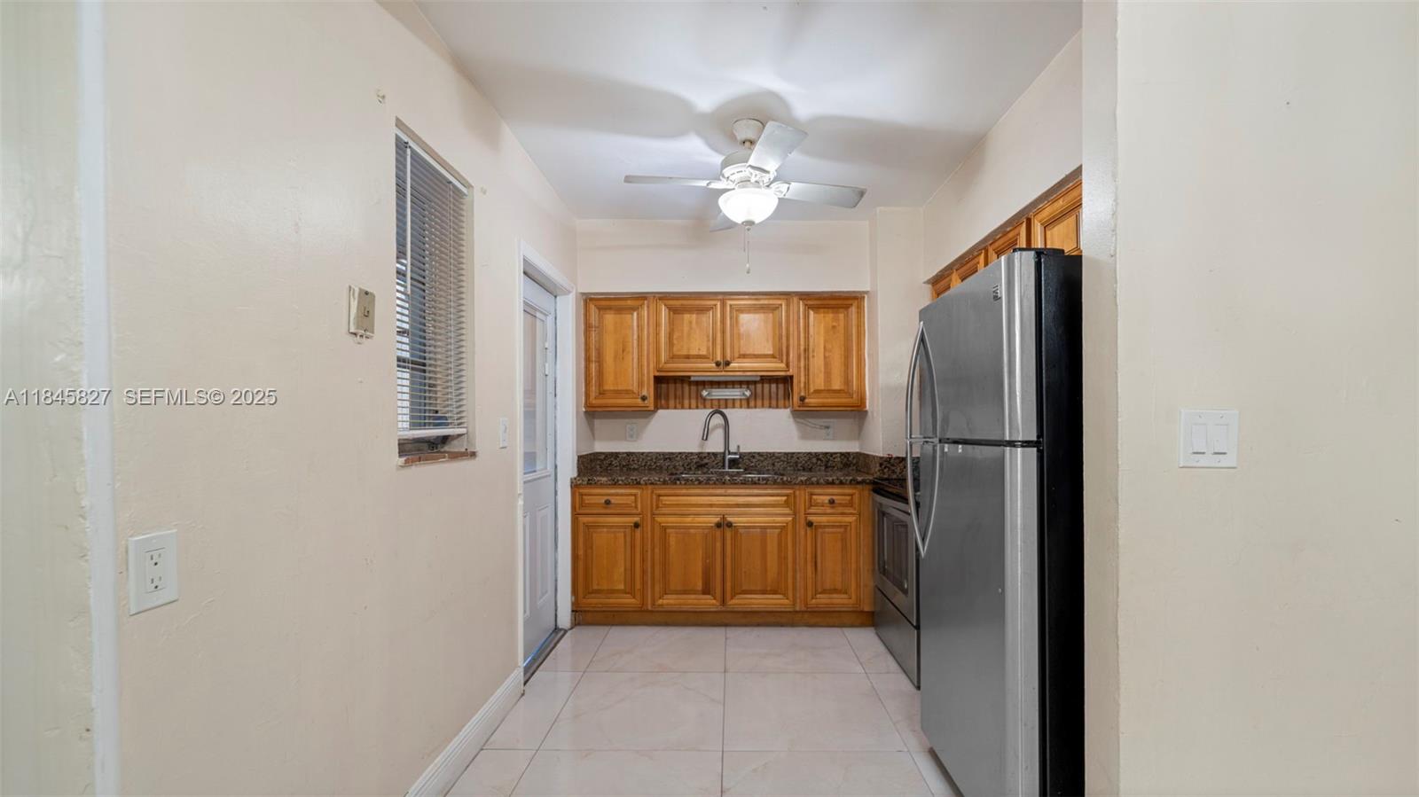 1235 Northwest 86th Street Miami, FL 33147 - Photo 14 of 37 a kitchen with a refrigerator a sink and dishwasher