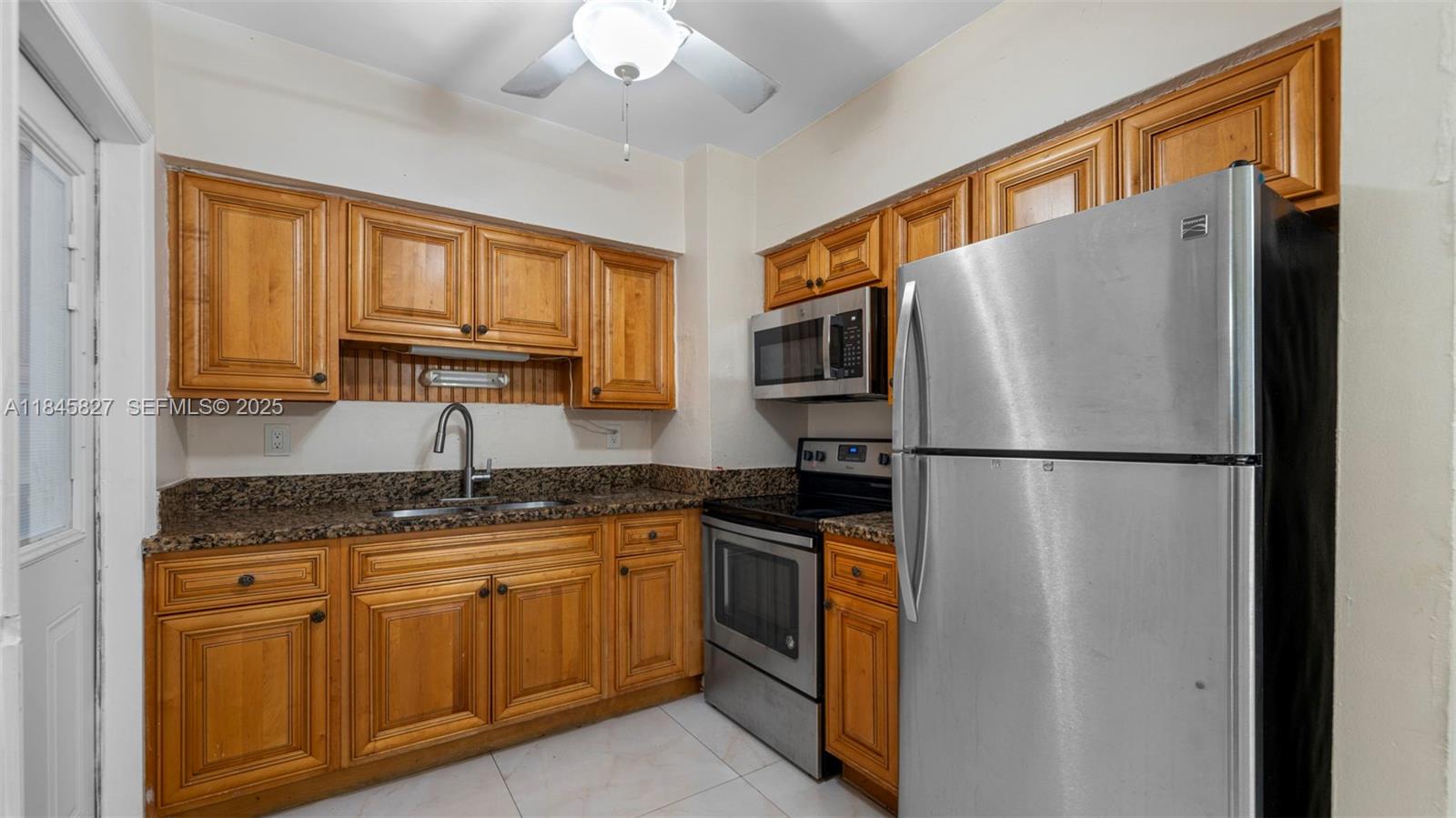 1235 Northwest 86th Street Miami, FL 33147 - Photo 15 of 37 a kitchen with appliances a sink and cabinets
