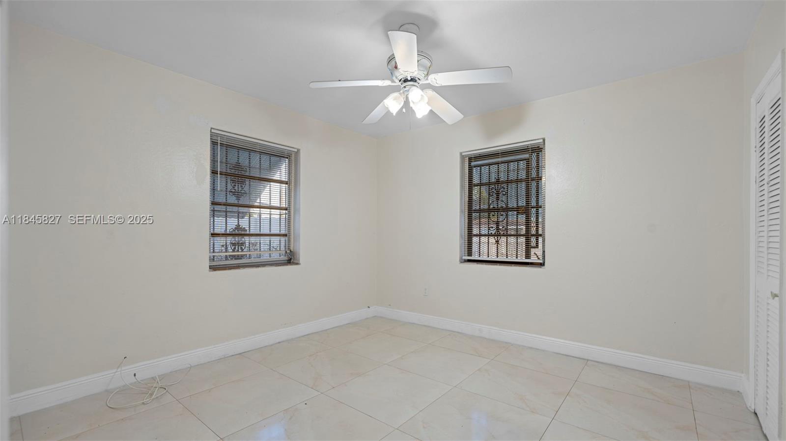 1235 Northwest 86th Street Miami, FL 33147 - Photo 20 of 37 an empty room with windows and fan