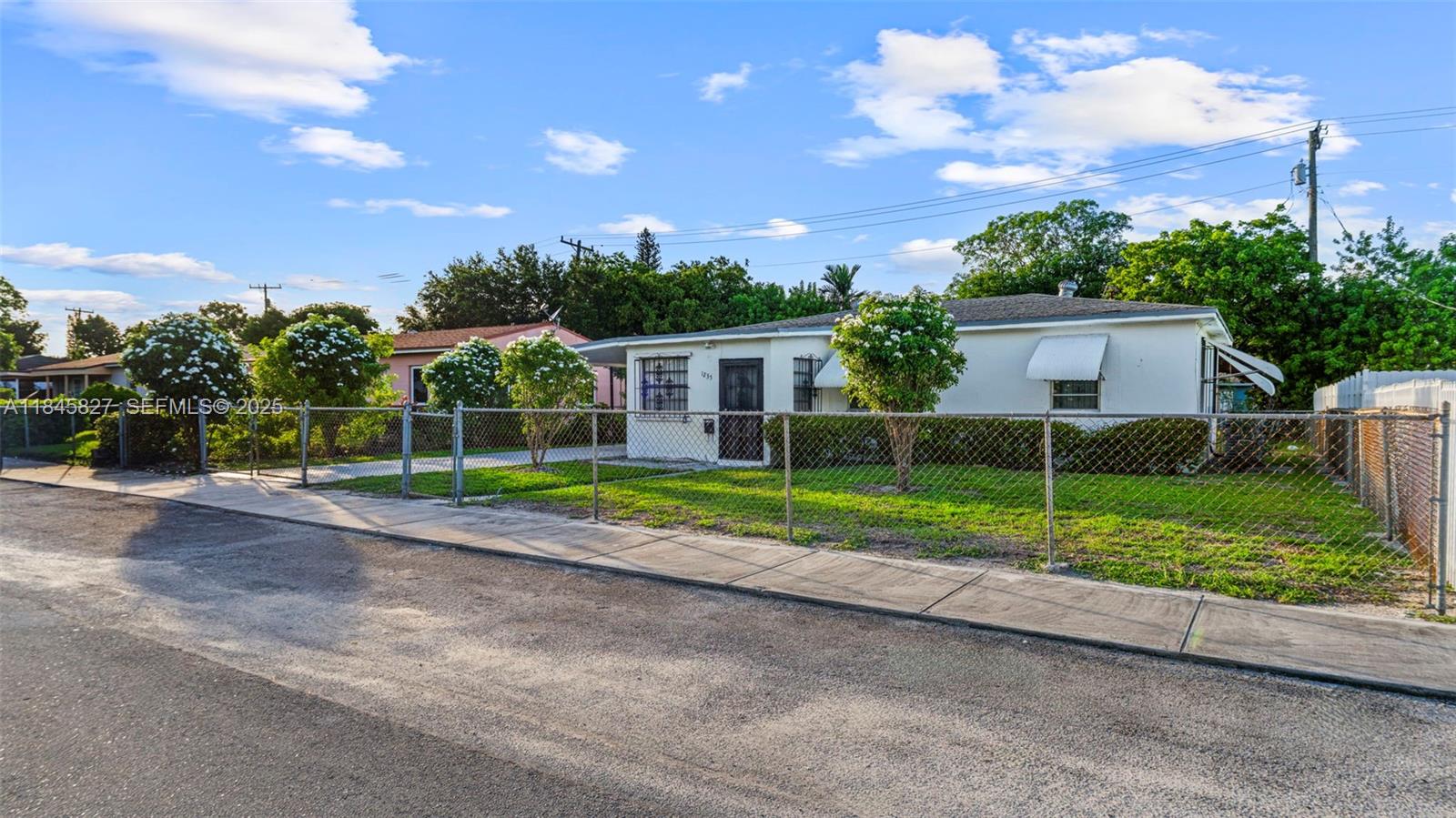 1235 Northwest 86th Street Miami, FL 33147 - Photo 2 of 37 a view of a house with a backyard and a garden