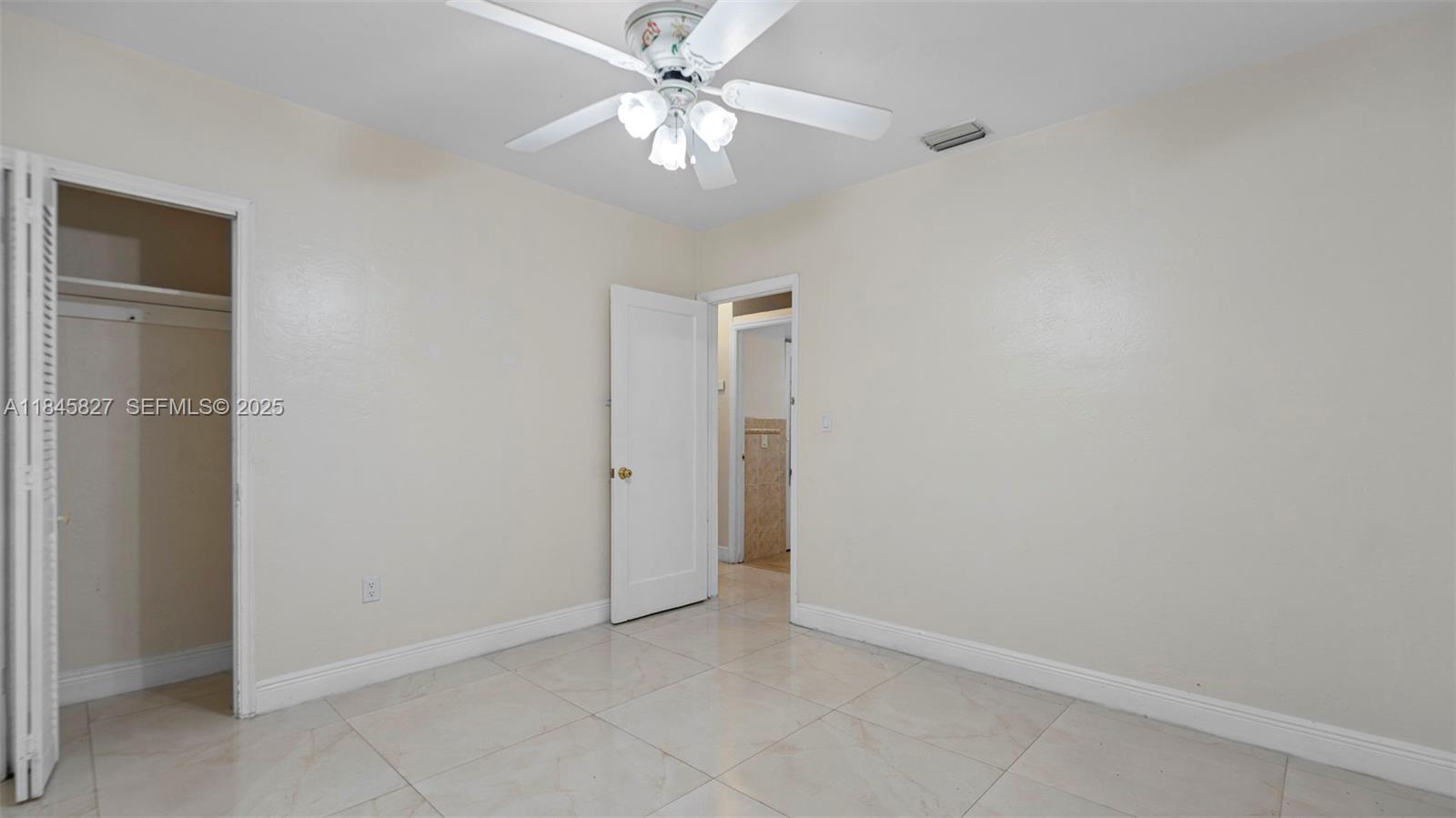 1235 Northwest 86th Street Miami, FL 33147 - Photo 21 of 37 an empty room with a ceiling fan and a fan