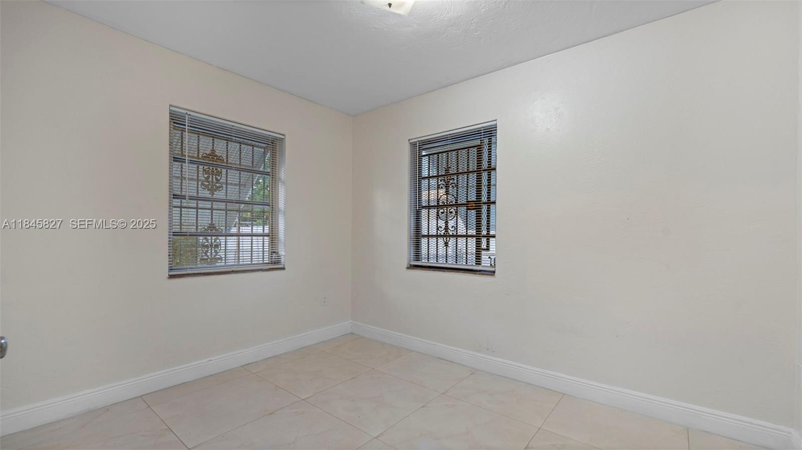 1235 Northwest 86th Street Miami, FL 33147 - Photo 22 of 37 an empty room with windows