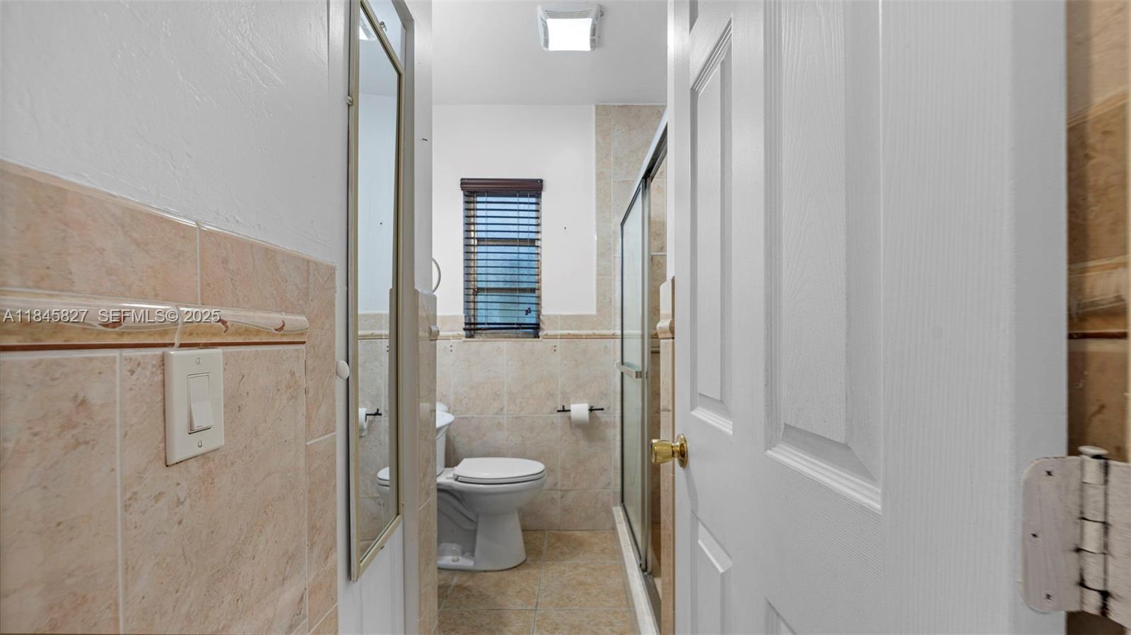 1235 Northwest 86th Street Miami, FL 33147 - Photo 25 of 37 a bathroom with a toilet and a shower