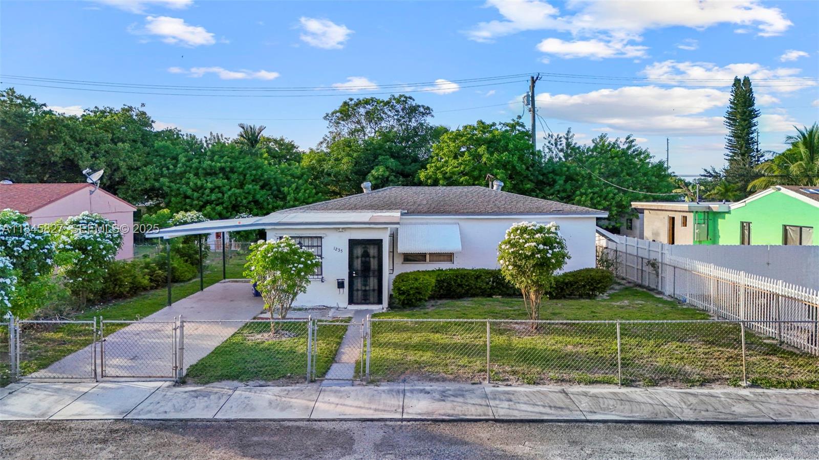 1235 Northwest 86th Street Miami, FL 33147 - Photo 29 of 37 a front view of a house with a yard