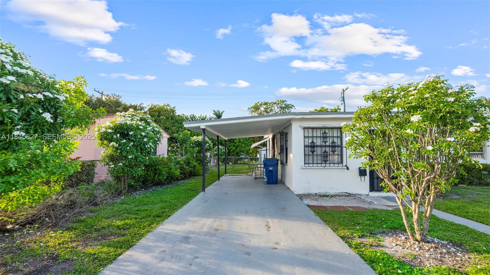 1235 Northwest 86th Street Miami, FL 33147 - Photo 5 of 37 a view of a house with a yard and garden