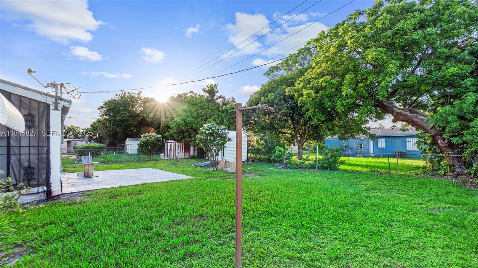 1235 Northwest 86th Street Miami, FL 33147 - Photo 9 of 37 a view of a big room with a big yard and large trees