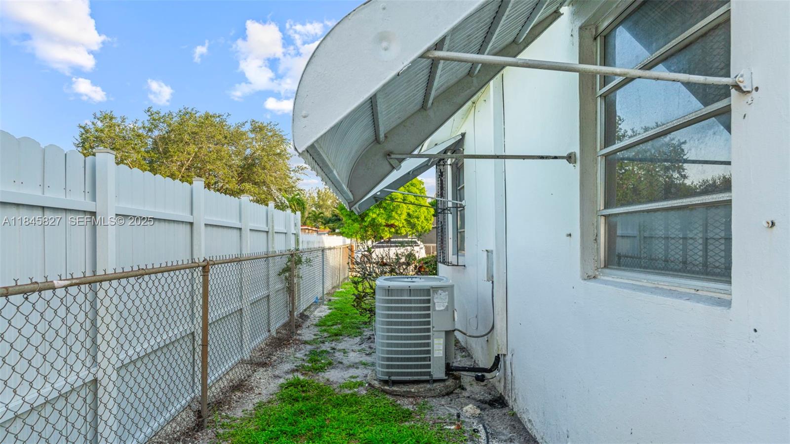 1235 Northwest 86th Street Miami, FL 33147 - Photo 10 of 37 a view of a house with a small yard and deck