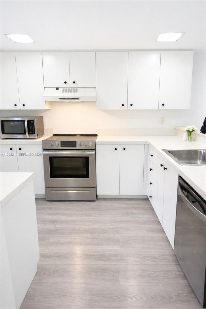 4321 Southwest 70th Terrace Davie, FL 33314 - Photo 4 of 15 a kitchen with cabinets appliances and a sink