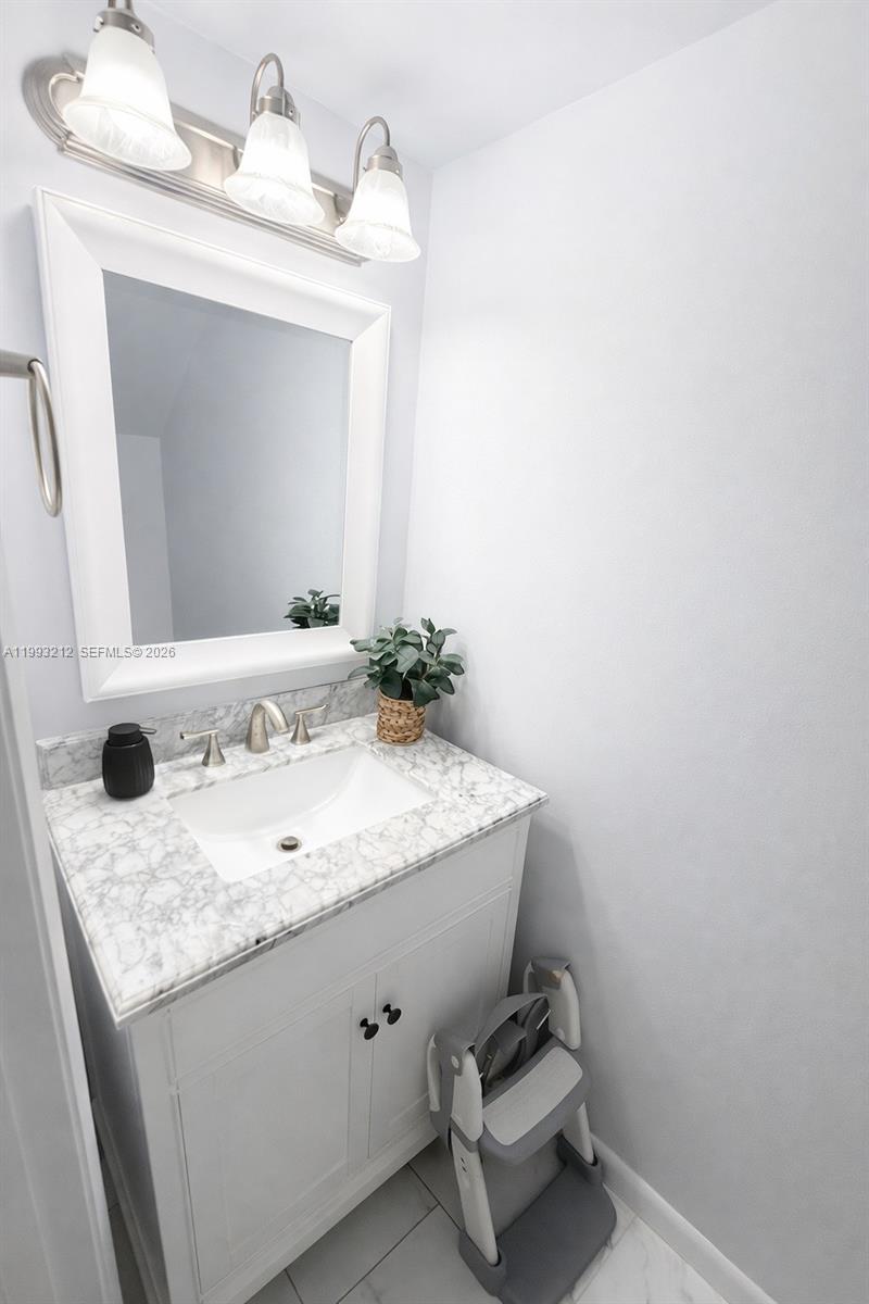 4321 Southwest 70th Terrace Davie, FL 33314 - Photo 7 of 15 a bathroom with a granite countertop sink and a mirror