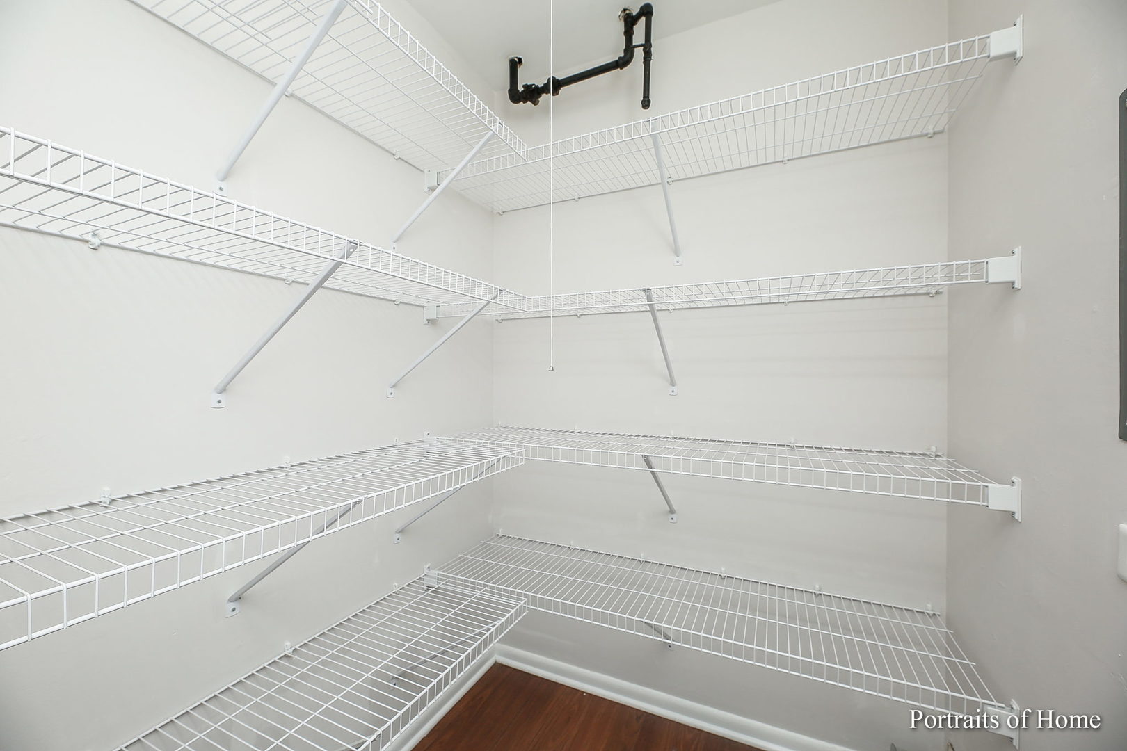 23 Hampton Road Montgomery, IL 60538 - Photo 8 of 16 a view of a room with racks on the wall