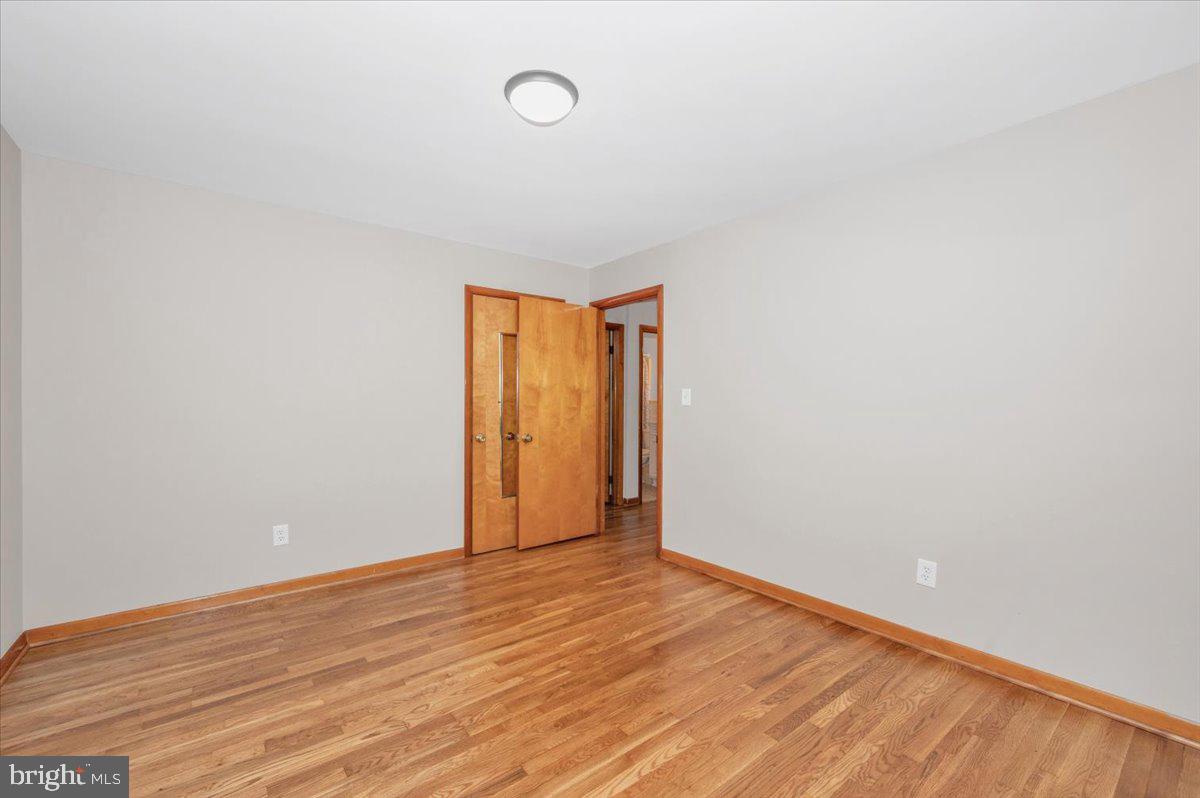 10508 Sweepstakes Road Damascus, MD 20872 - Photo 19 of 46 a view of an empty room with wooden floor and a window