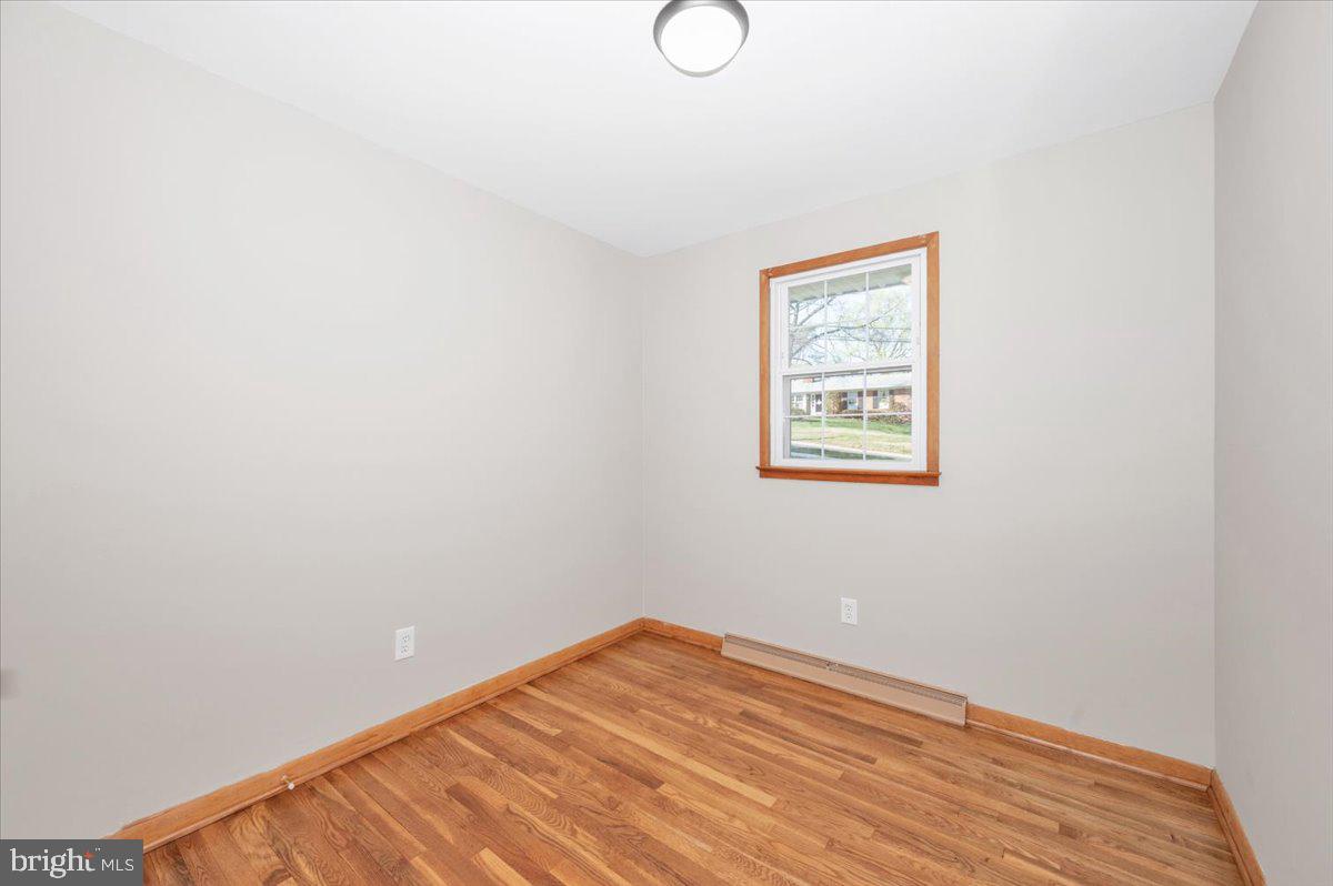 10508 Sweepstakes Road Damascus, MD 20872 - Photo 20 of 46 a view of a room with wooden floor and white walls
