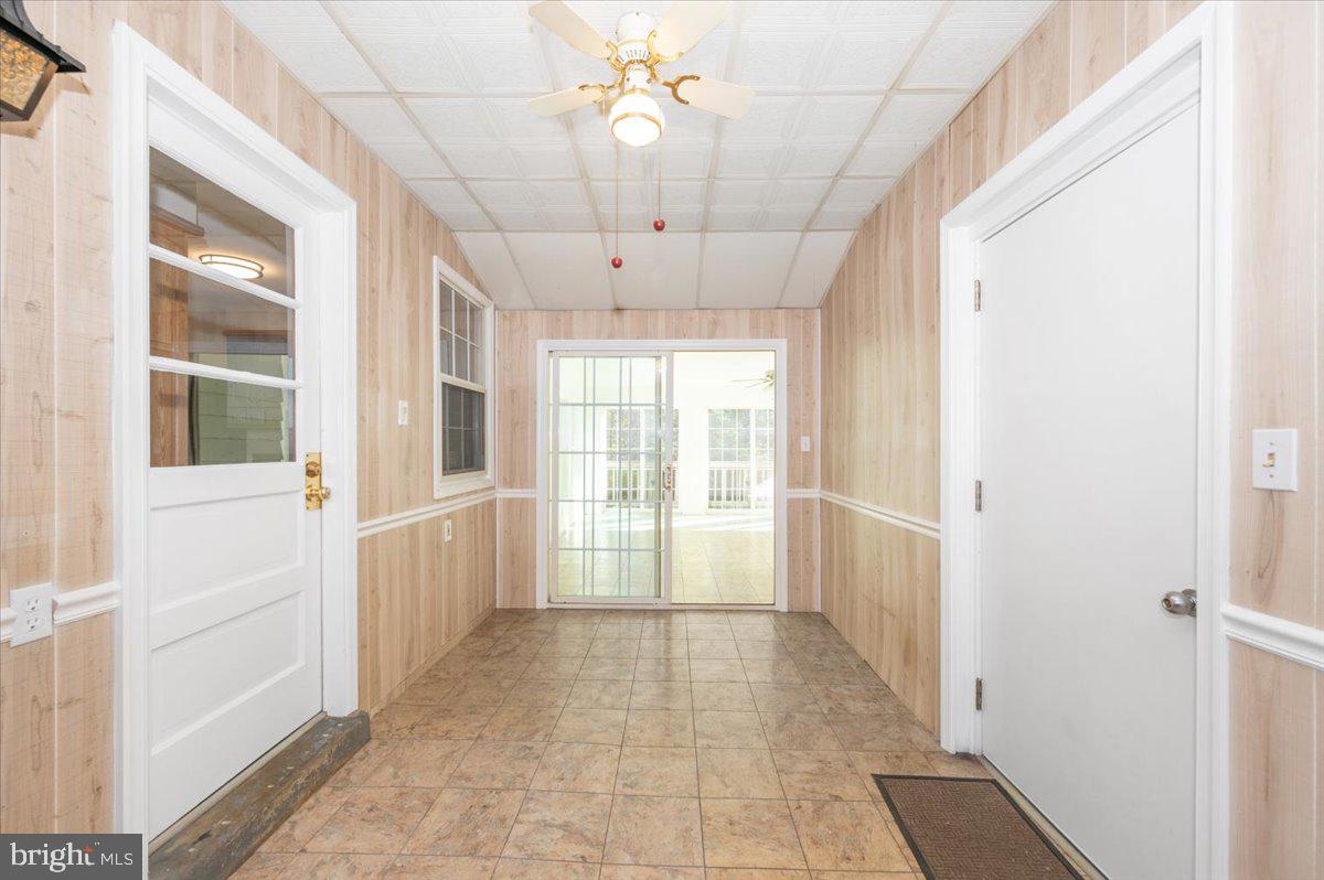 10508 Sweepstakes Road Damascus, MD 20872 - Photo 24 of 46 a view of a hallway with a chandelier fan and windows