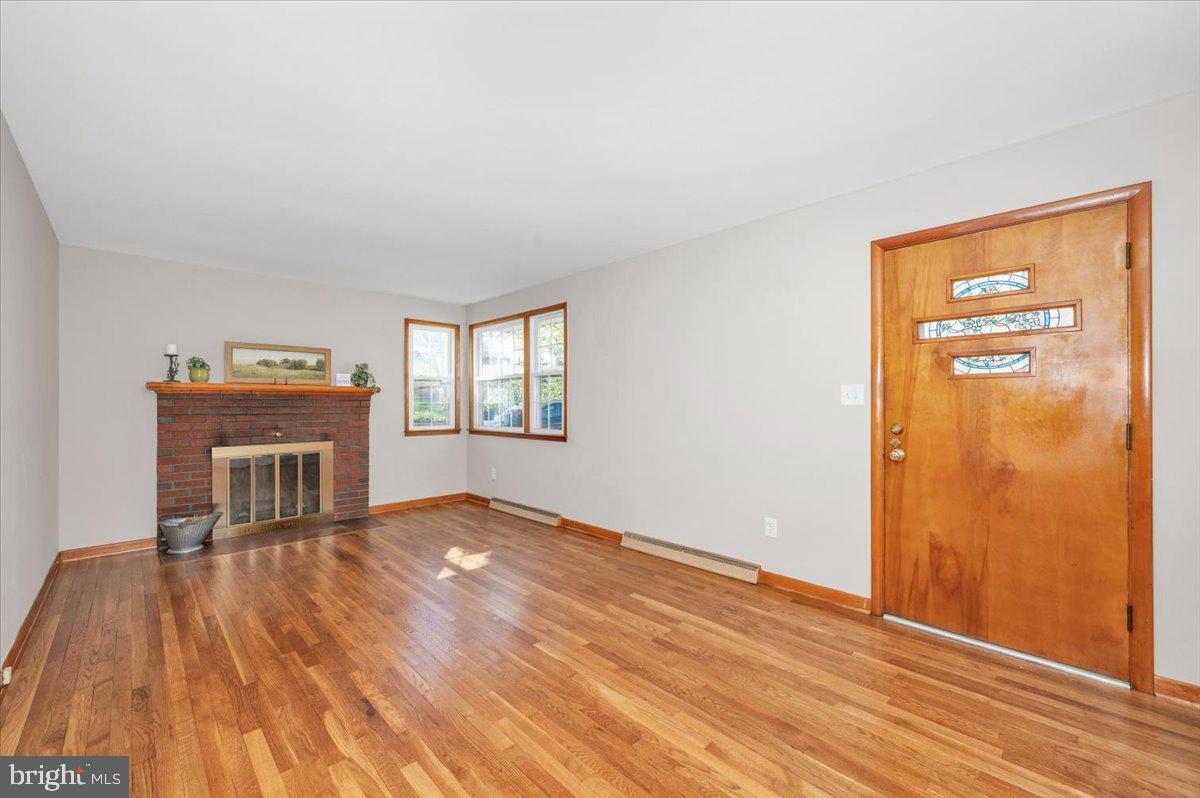 10508 Sweepstakes Road Damascus, MD 20872 - Photo 4 of 46 a view of empty room with wooden floor and fireplace