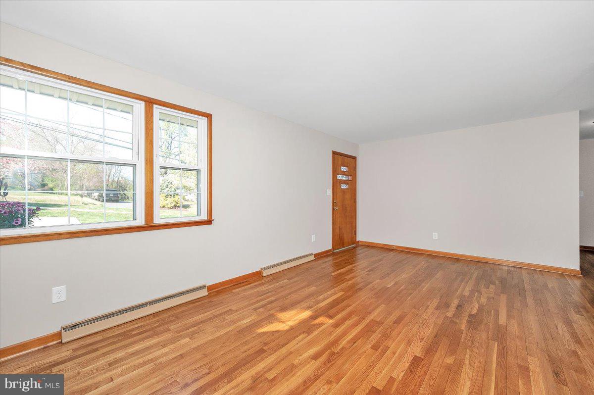 10508 Sweepstakes Road Damascus, MD 20872 - Photo 6 of 46 a view of an empty room with wooden floor and a window