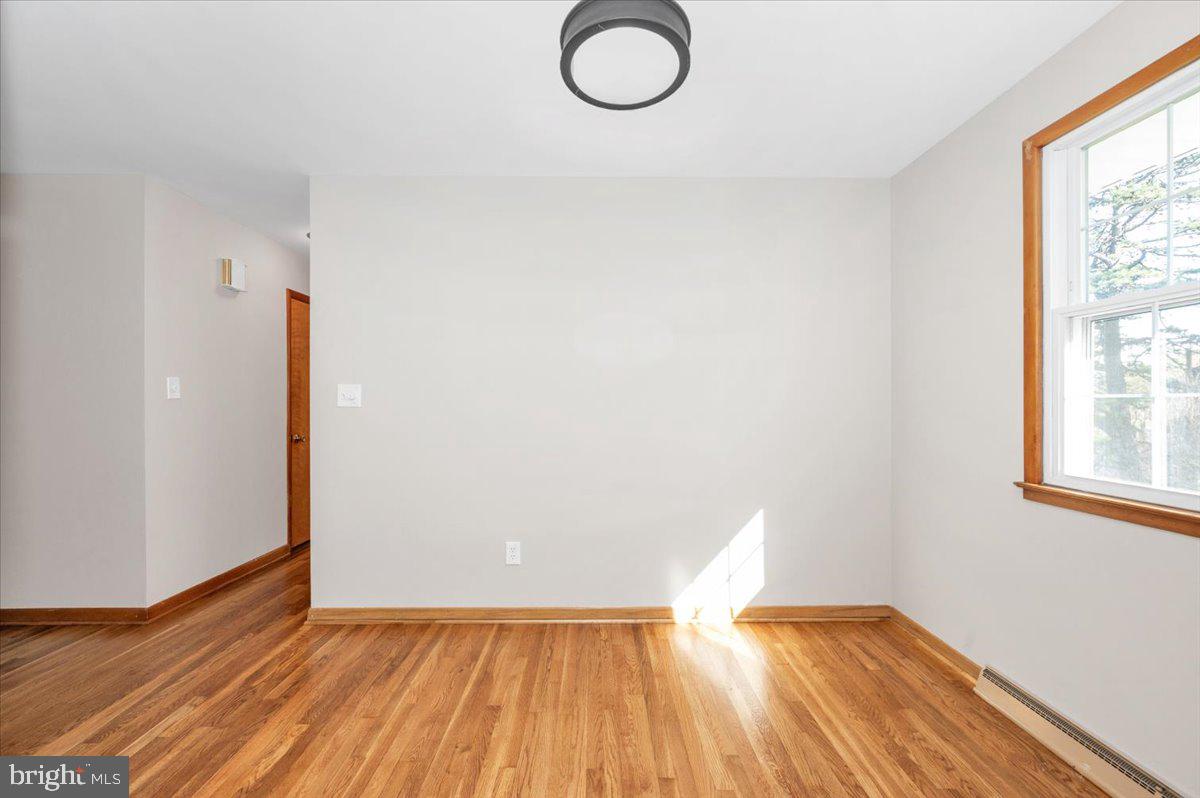 10508 Sweepstakes Road Damascus, MD 20872 - Photo 8 of 46 an empty room with wooden floor and windows