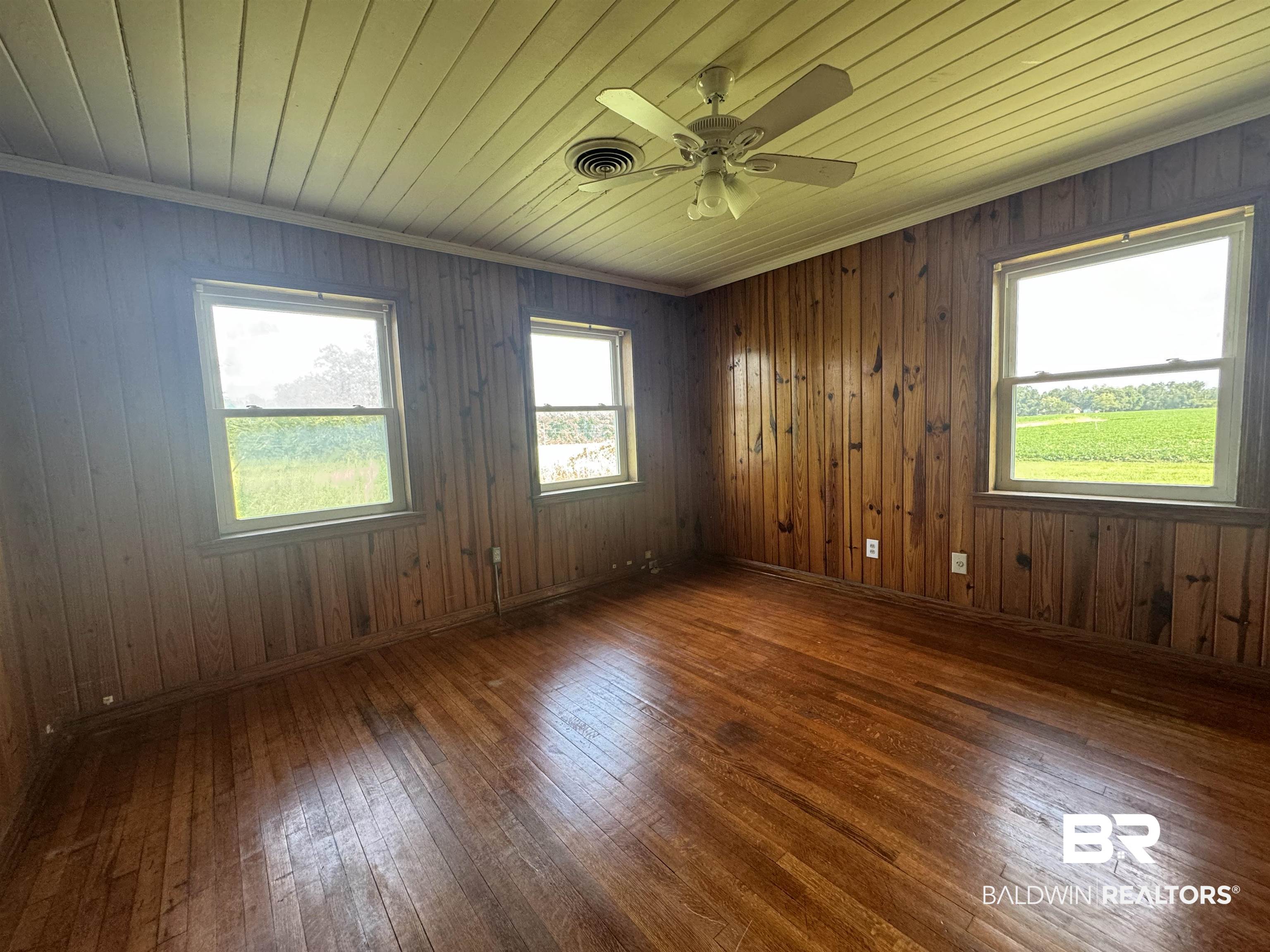 22720 Highway 31 Flomaton, AL 36441 - Photo 19 of 22 Unfurnished room featuring dark wood-type flooring, wooden ceiling, and wood walls