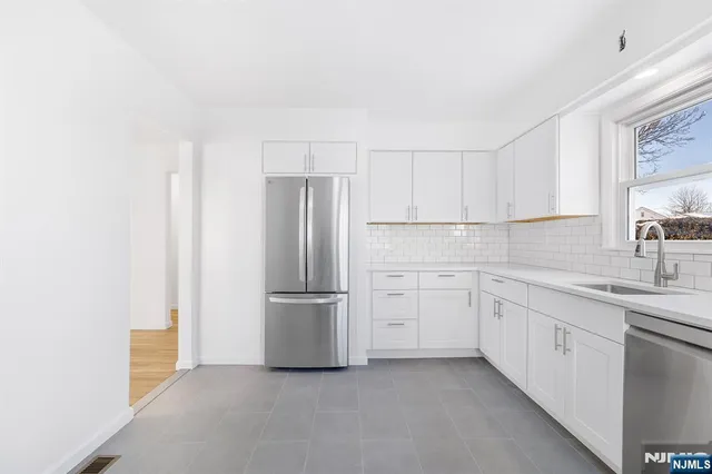 a kitchen with cabinets and stainless steel appliances