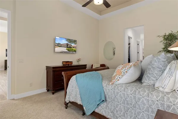 a living room with patio furniture and a floor to ceiling window