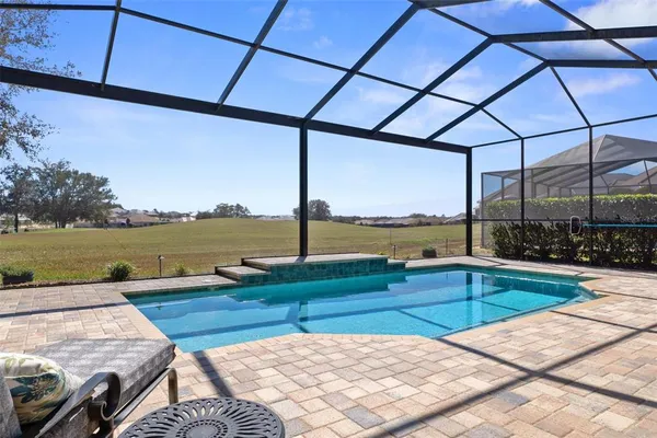 an aerial view of a house with yard swimming pool and outdoor seating