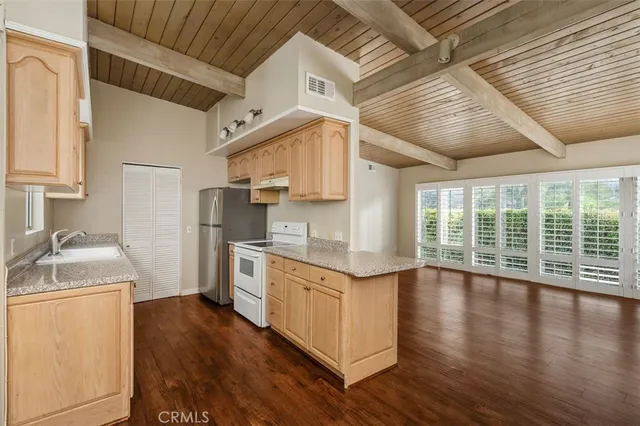 a kitchen with a stove a sink and a refrigerator