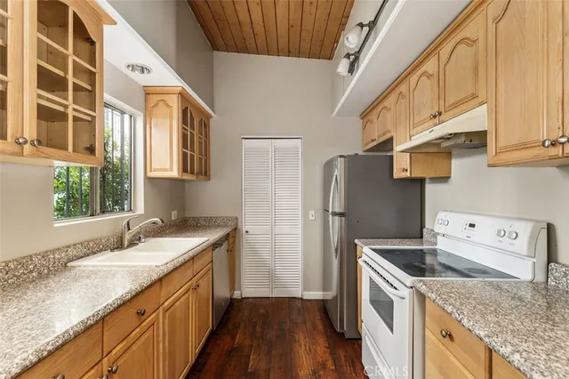 a kitchen with a sink a stove and a refrigerator