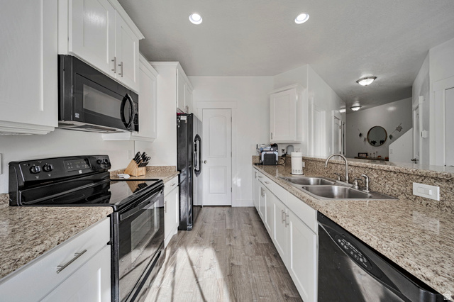 11730 South Shadow Lane Draper, UT 84020 - Photo 8 of 24 Kitchen featuring black appliances, white cabinetry, and light stone countertops