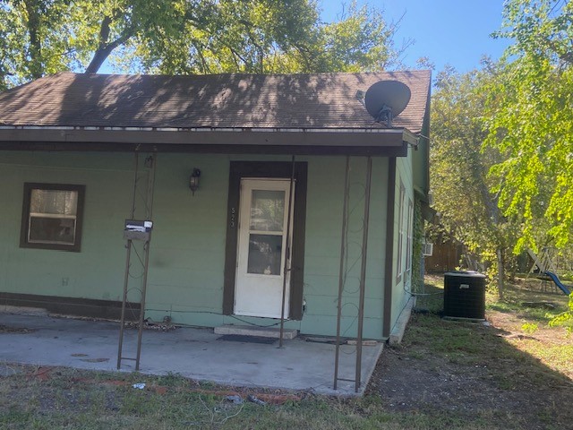 523 South Rio Grande Street Lockhart, TX 78644 - Photo 2 of 16 Doorway to property with a shingled roof