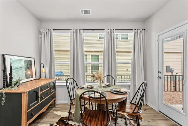 a view of a dining room with furniture and windows