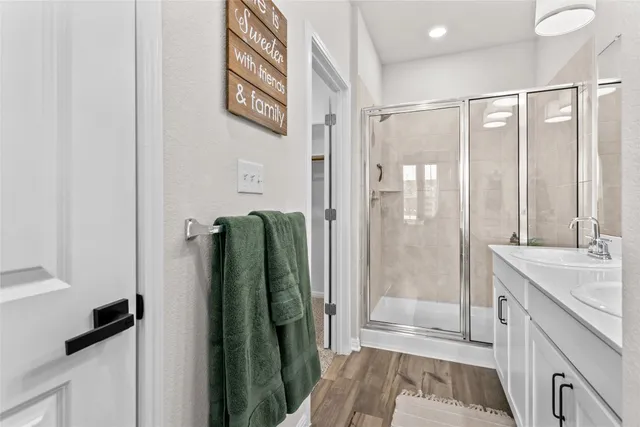 a bathroom with a double vanity sink and a mirror
