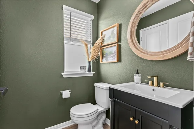 a bathroom with a sink a toilet and a mirror