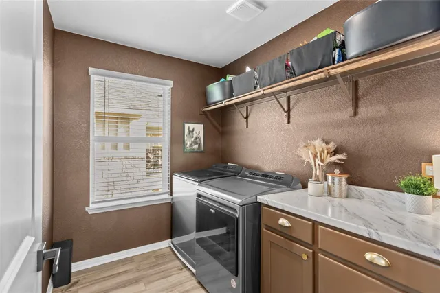 a kitchen with a sink cabinets and a window